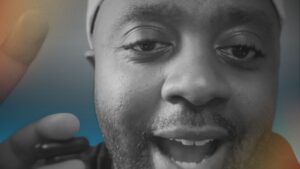 Close-up of Mark Allen Patterson speaking with focus and energy, symbolizing personal growth and the commitment to getting 1% better each day